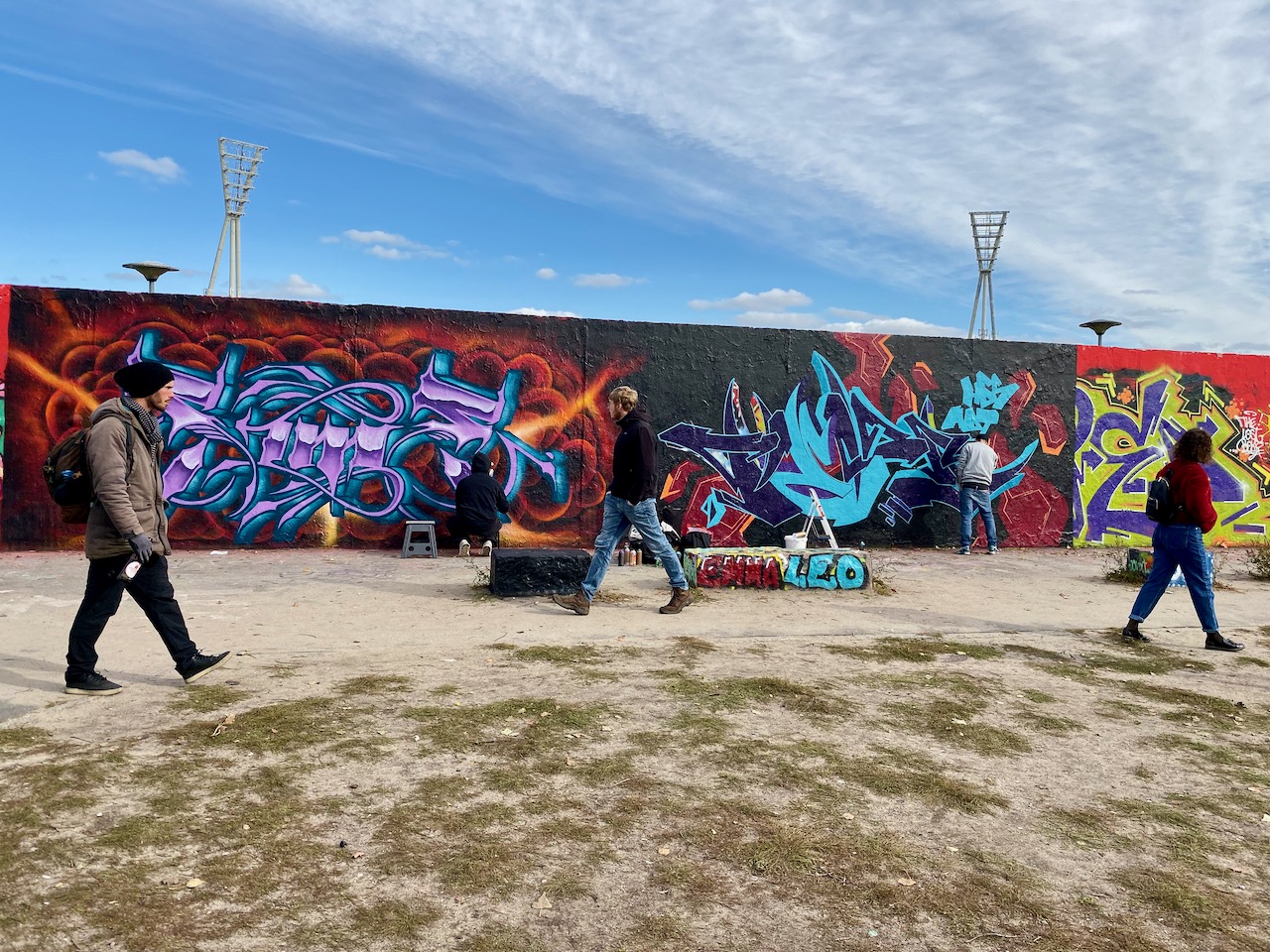 Watching graffiti artists working on a section of the wall in Mauerpark